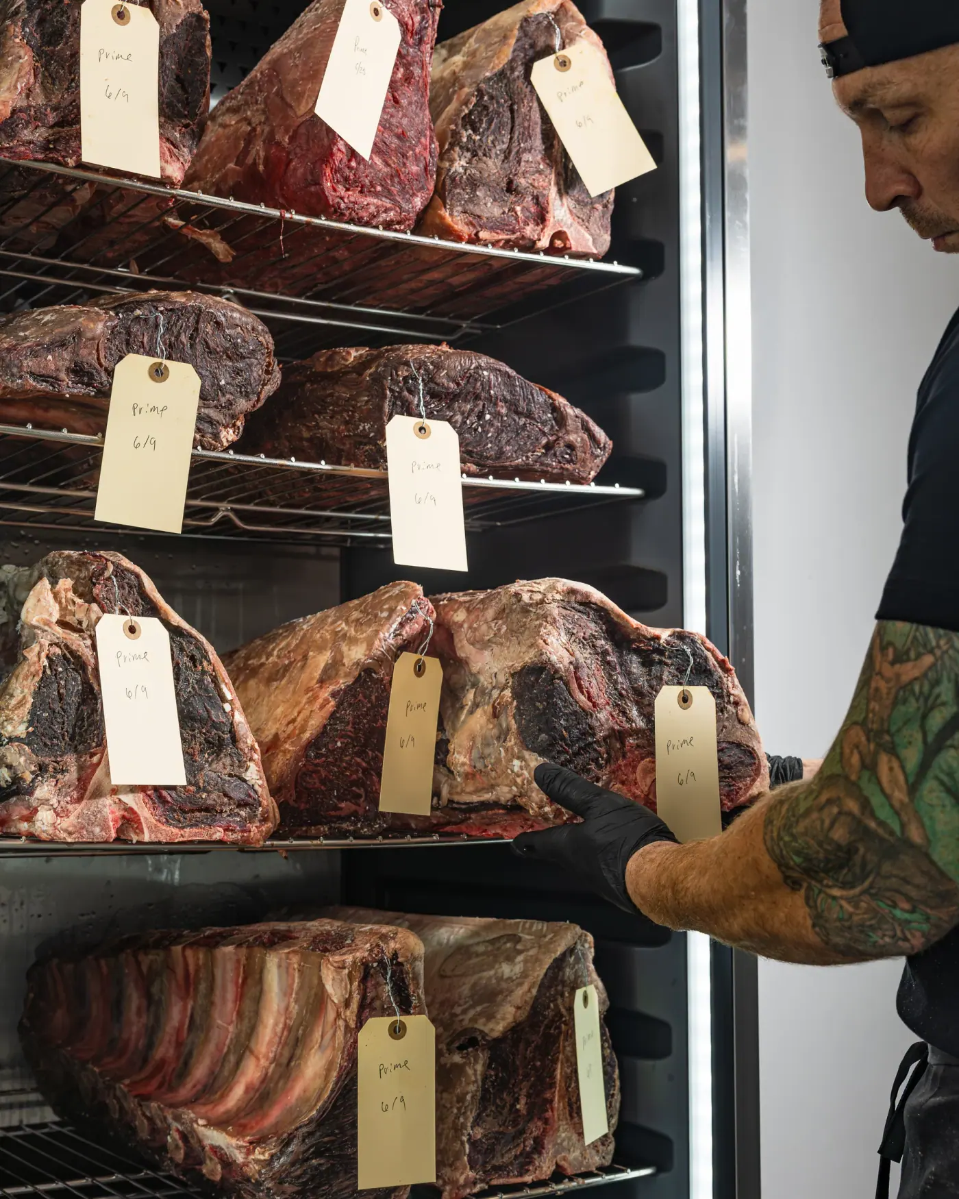 A butcher inspecting dry-aged beef