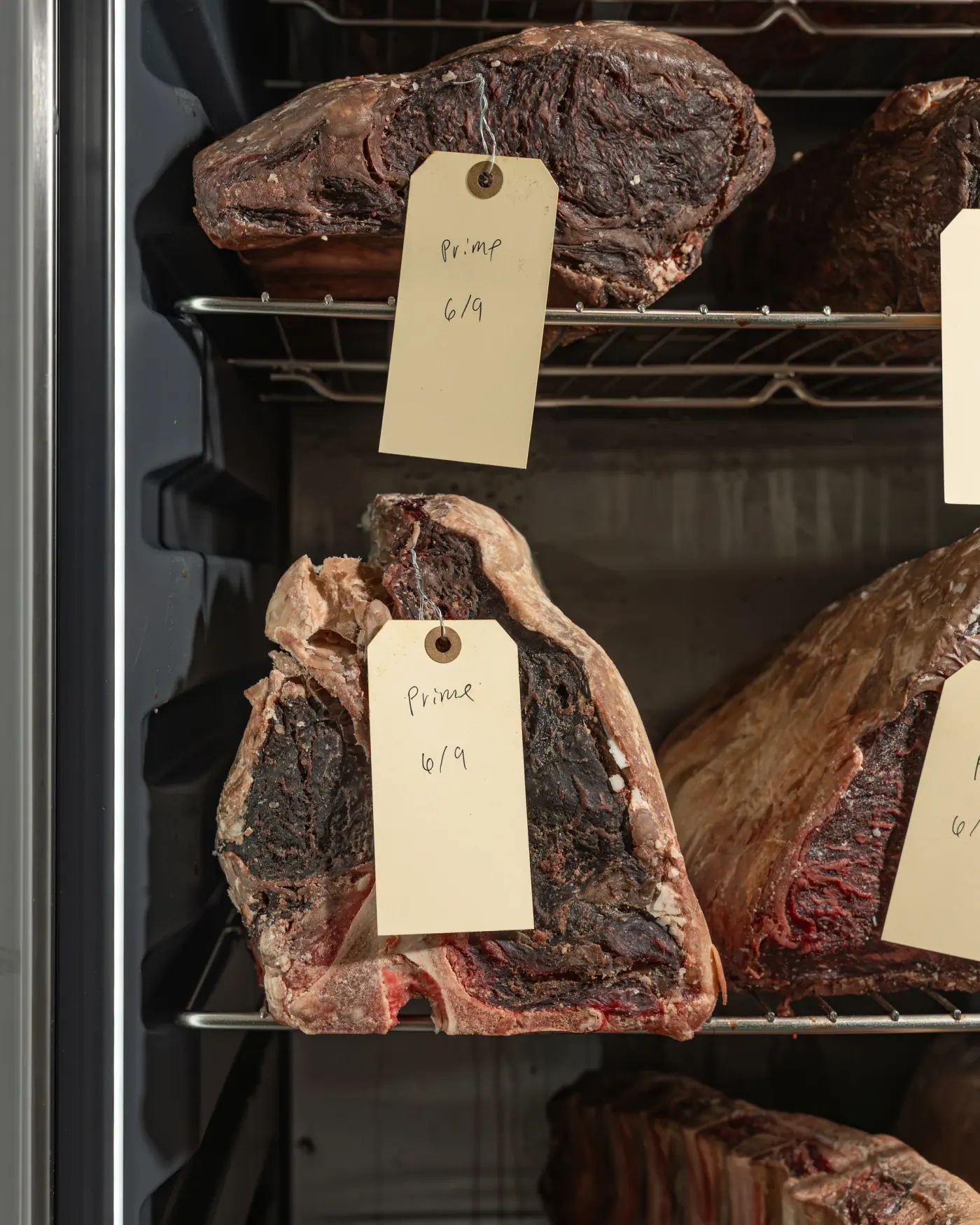 A dry-aged porterhouse tagged on the rail