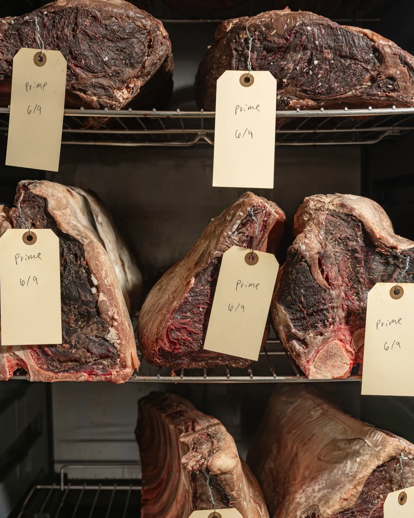 Tagged dry-aged beef hanging on the rail