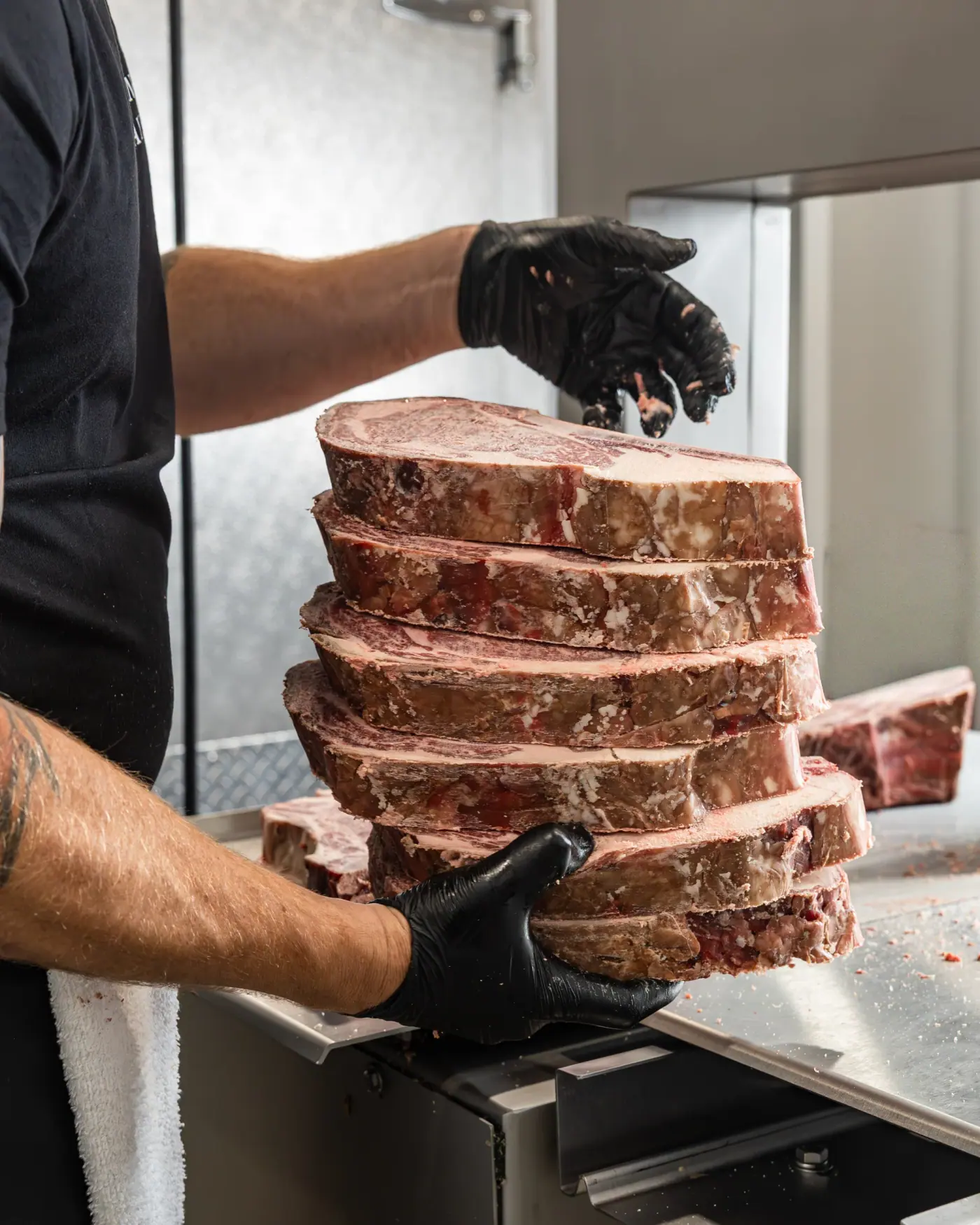 A stack of cut steaks lifted from the block