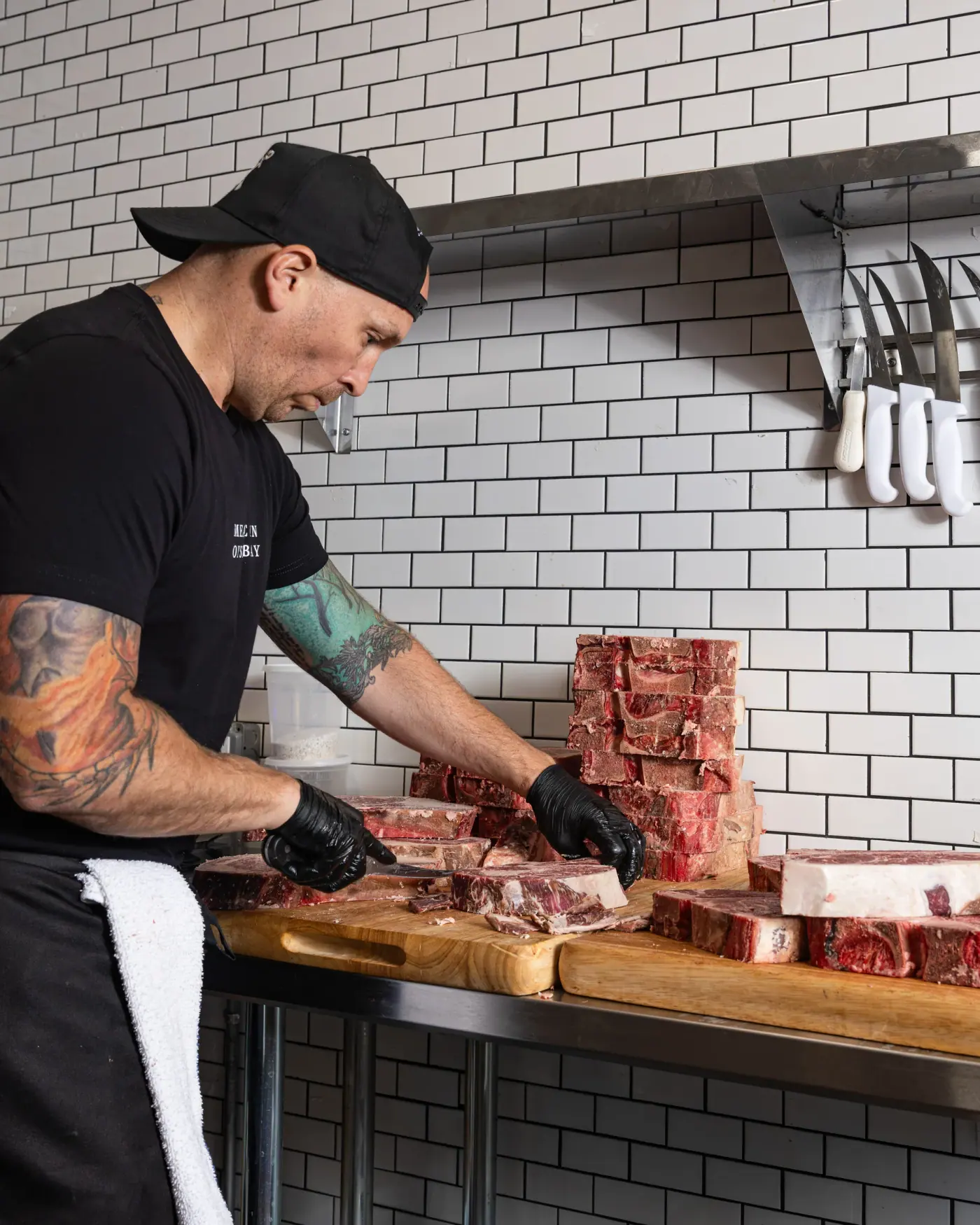 Short ribs being trimmed against the tile wall